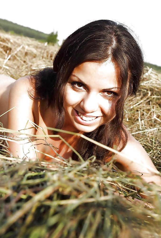 25P Hot brunett teen plays outdoor in the hay