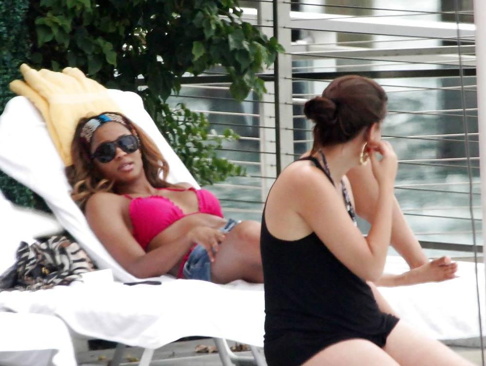 24P Ciara in a pink bikini poolside at her luxury hotel in Miami