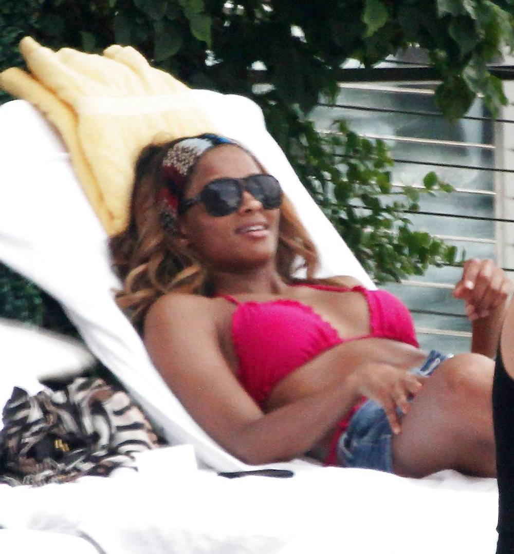 24P Ciara in a pink bikini poolside at her luxury hotel in Miami