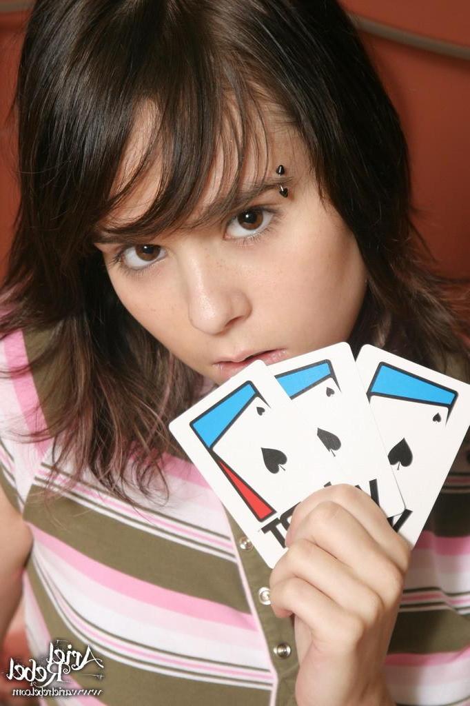 15P Pictures of teen Ariel Rebel playing a game of cards in bed