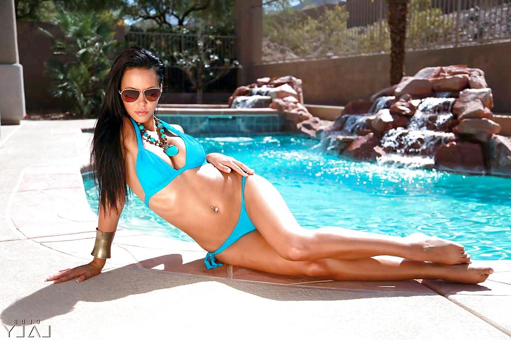 16P Immensely sexy brunette babe in glasses tans over the swimming pool