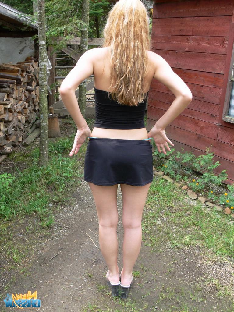 20P Pictures of teen babe Nikky Cassidy stripping in the back yard