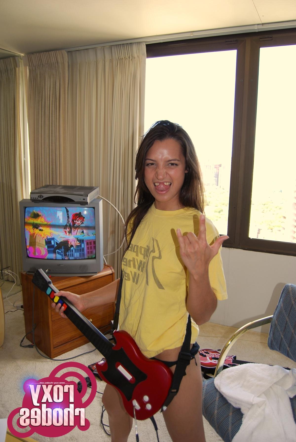 15P Pictures of teen girl Roxy Rhodes playing a sexy game of guitar hero