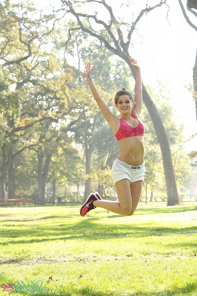 15P Athletic girl Stella Xo stretches and teases in the park