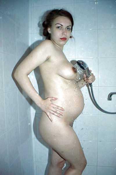 24P Pregnant brunette showing off her body and belly