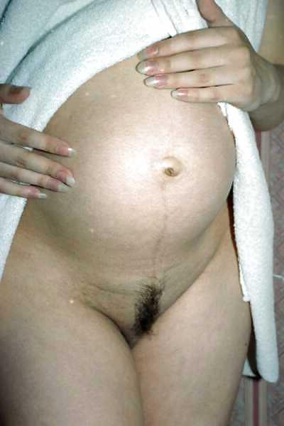 24P Pregnant brunette showing off her body and belly