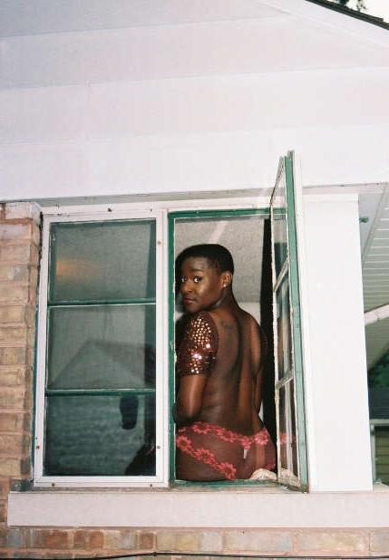 12P Black chick with short hair poses like a model