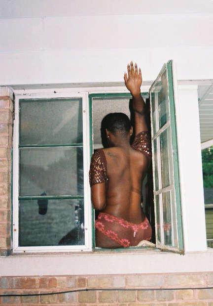 12P Black chick with short hair poses like a model