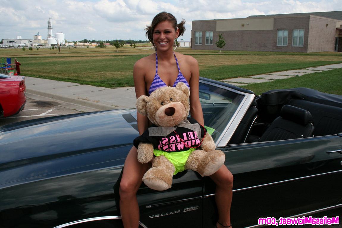 15P Melissa Midwest posing on cars at a car show