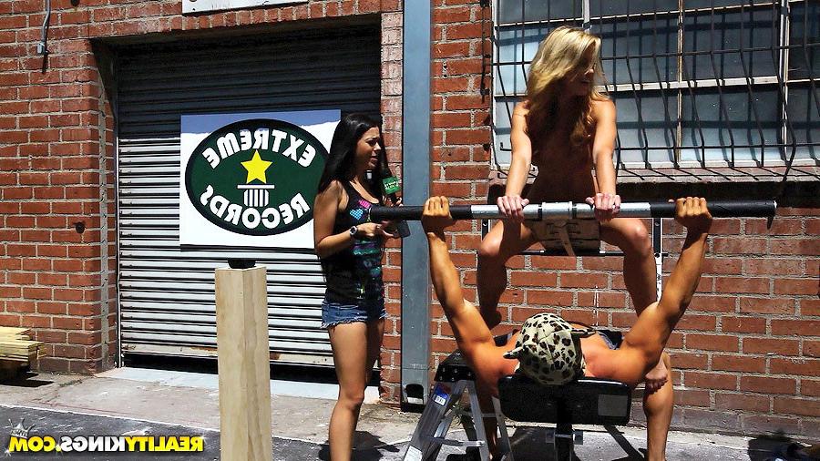 14P Check out this hot bikini babe get bench pressed in front or a  record shop then