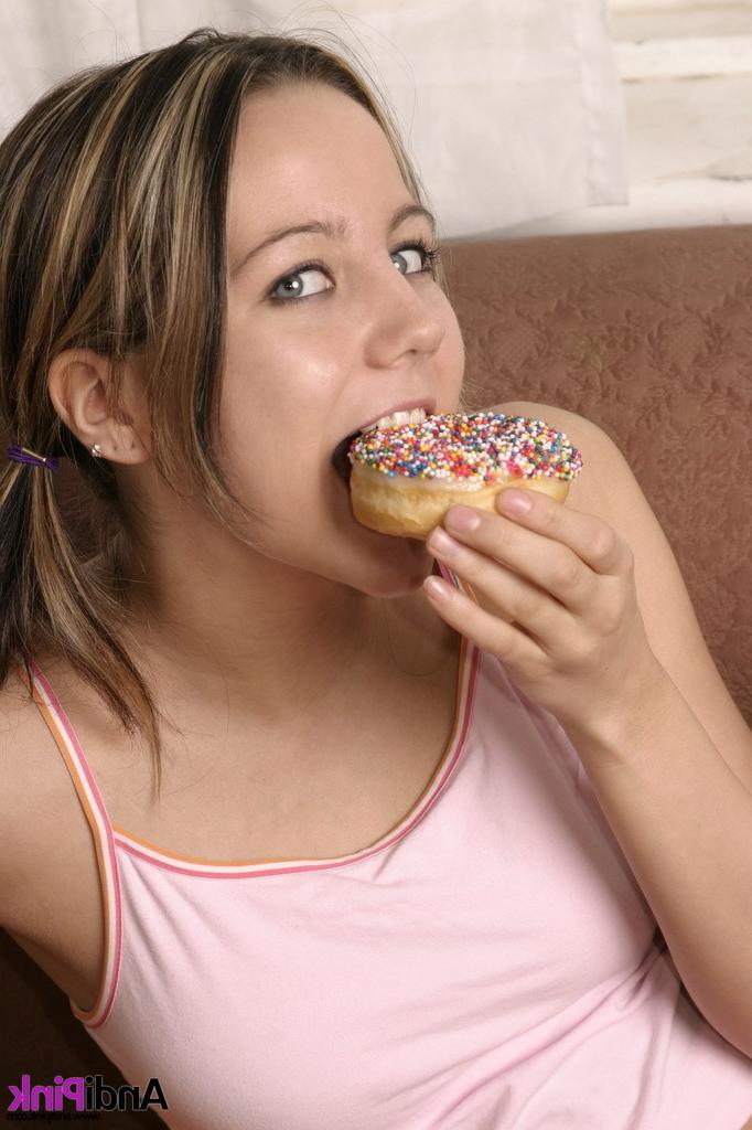 15P Andi Pink eating donuts on a couch
