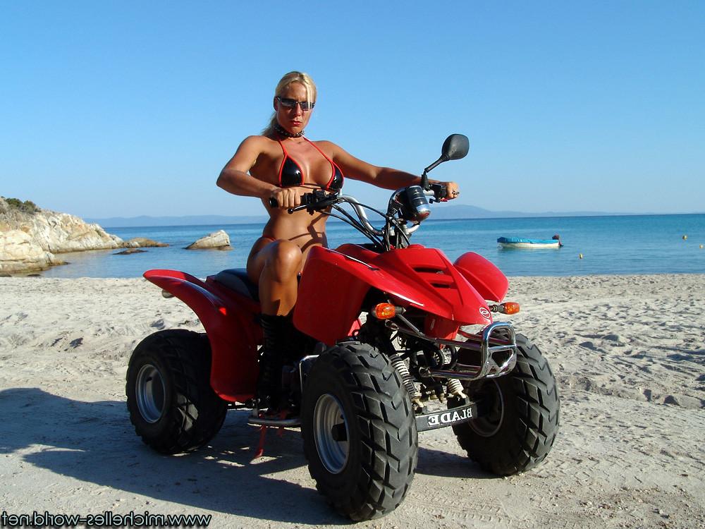15P Dark tanned female muscles at  the beach