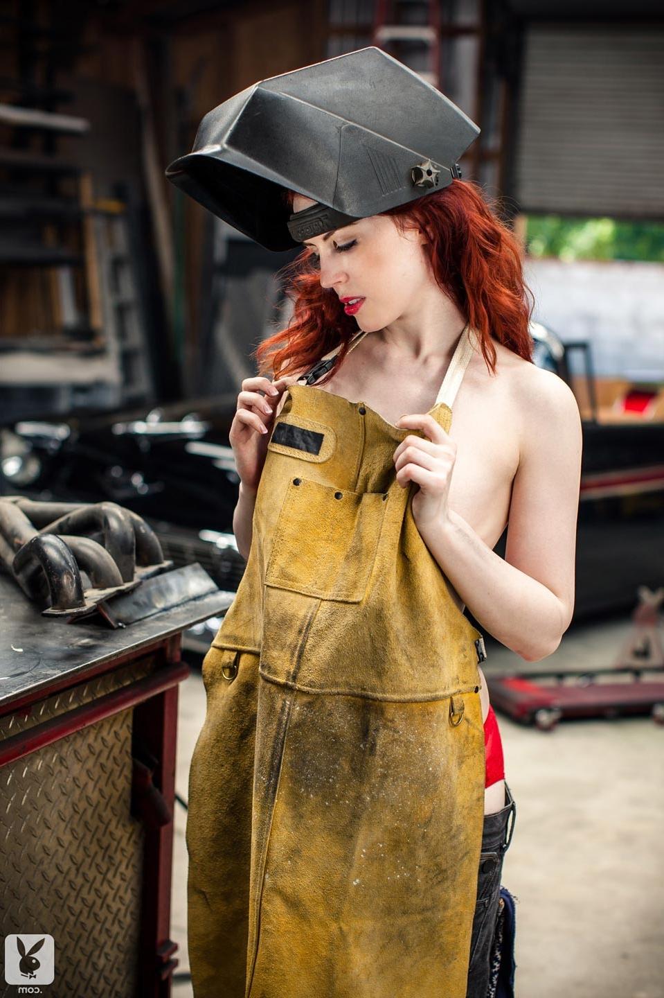 15P Horny redhead model strips in a big car garage