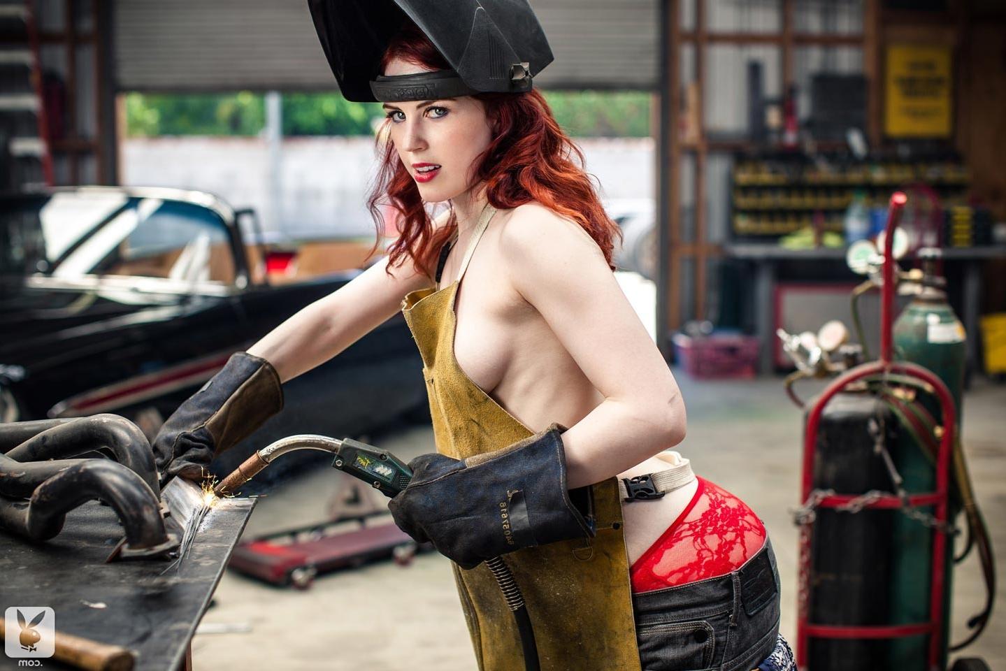 15P Horny redhead model strips in a big car garage