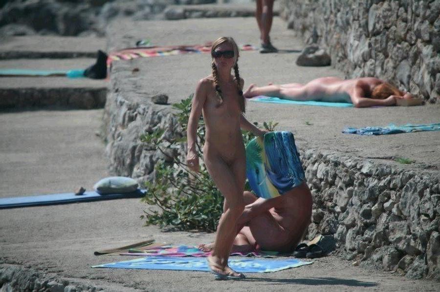15P Check out this sexy nudist showing off her shaved pussy