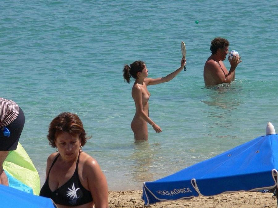 15P Check out this sexy nudist showing off her shaved pussy