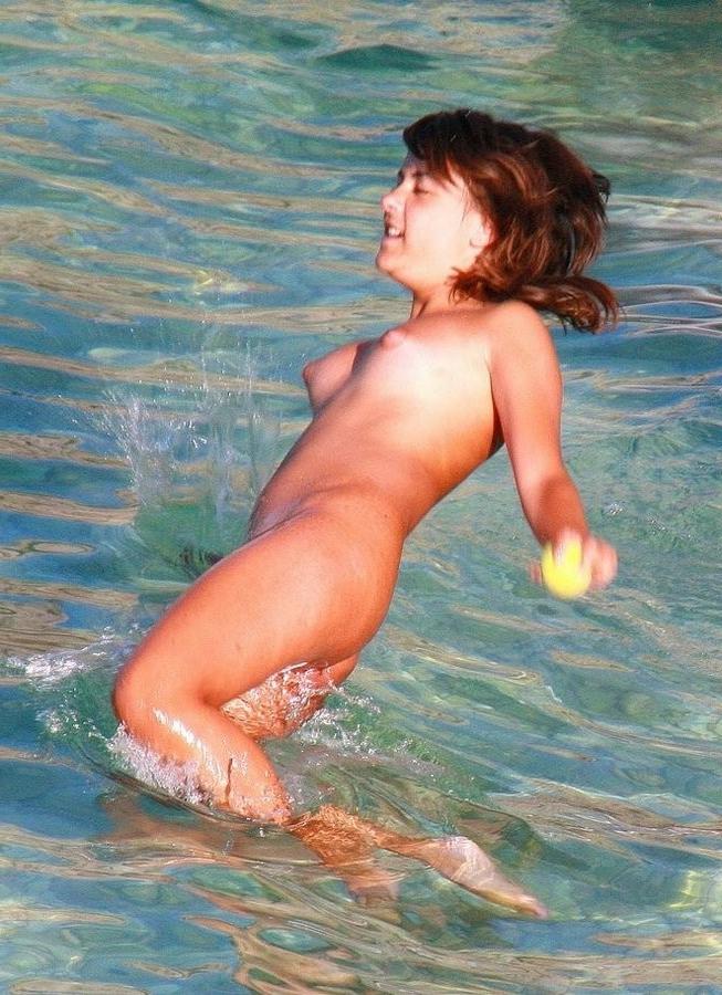 15P Gorgeous blonde young nudist plays in the water