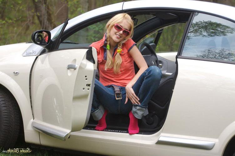 17P Attractive young blonde model showing hot striptease in her car