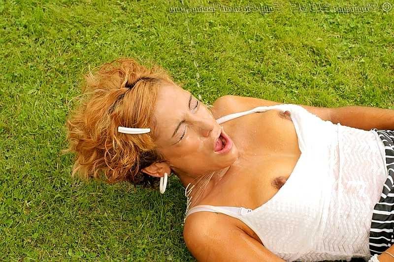 20P Two guys pissing over a redhead on an outdoor soccer field
