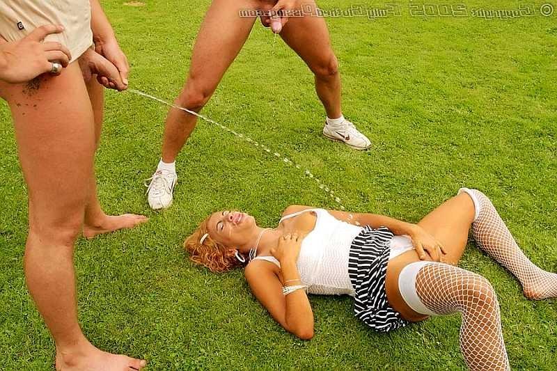 20P Two guys pissing over a redhead on an outdoor soccer field