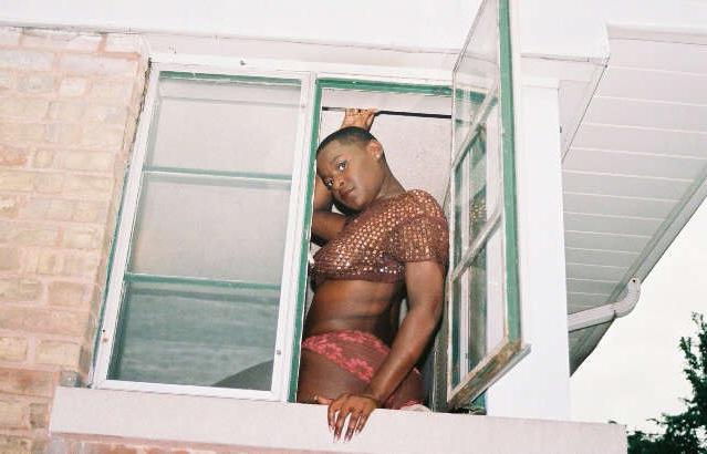 16P Black chick with short hair poses like a model