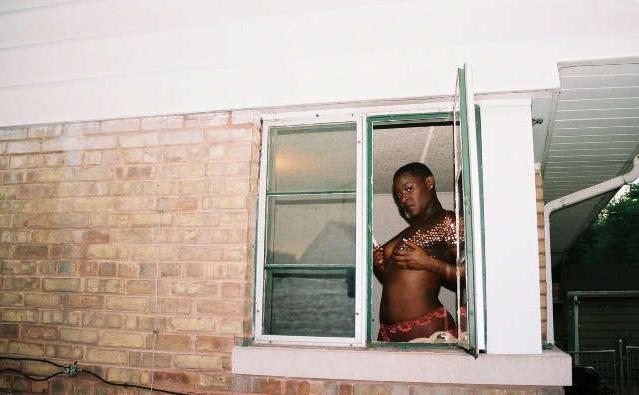 16P Black chick with short hair poses like a model