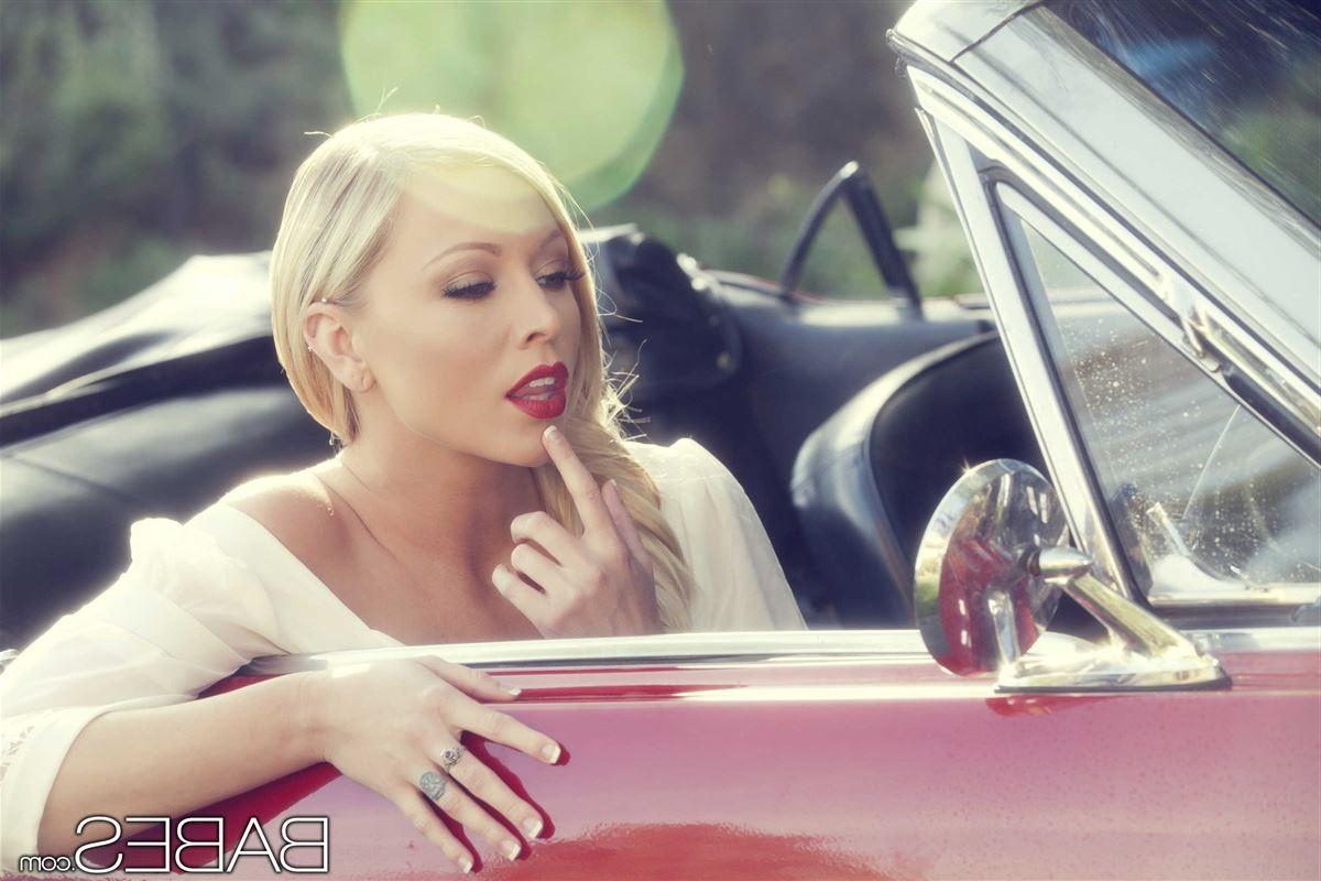 16P Brea Bennett touches herself on a red classic car