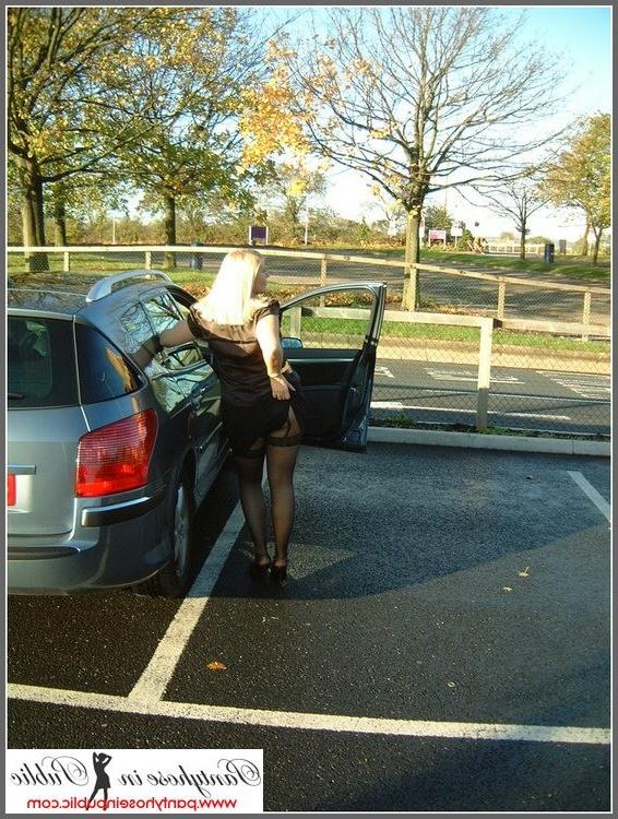 15P amateur woman posing in stockings in a car