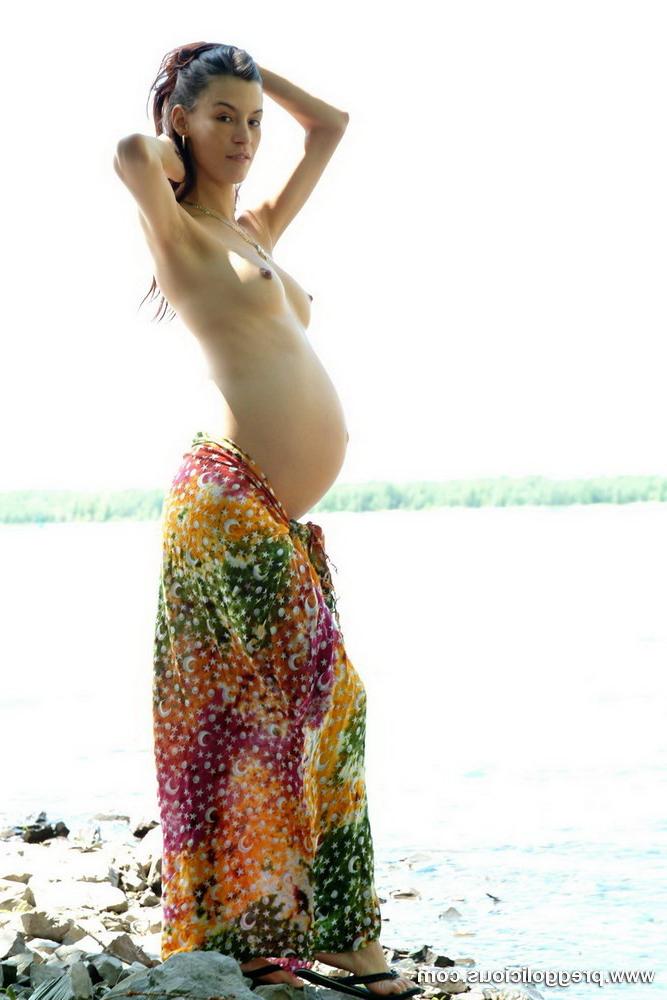 16P Pregnant beauty posing with her round belly outdoors