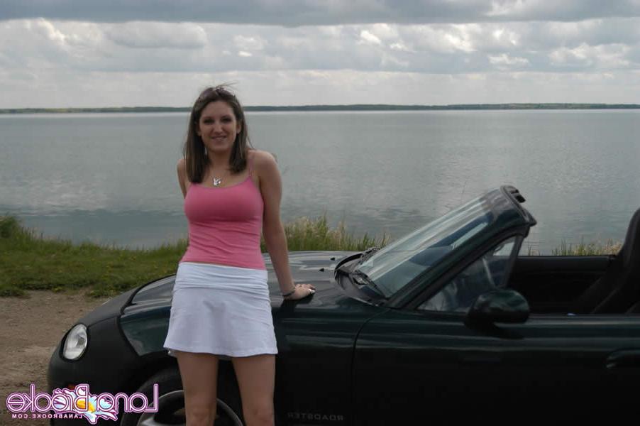 15P Brunette teen with big tits poses by a car