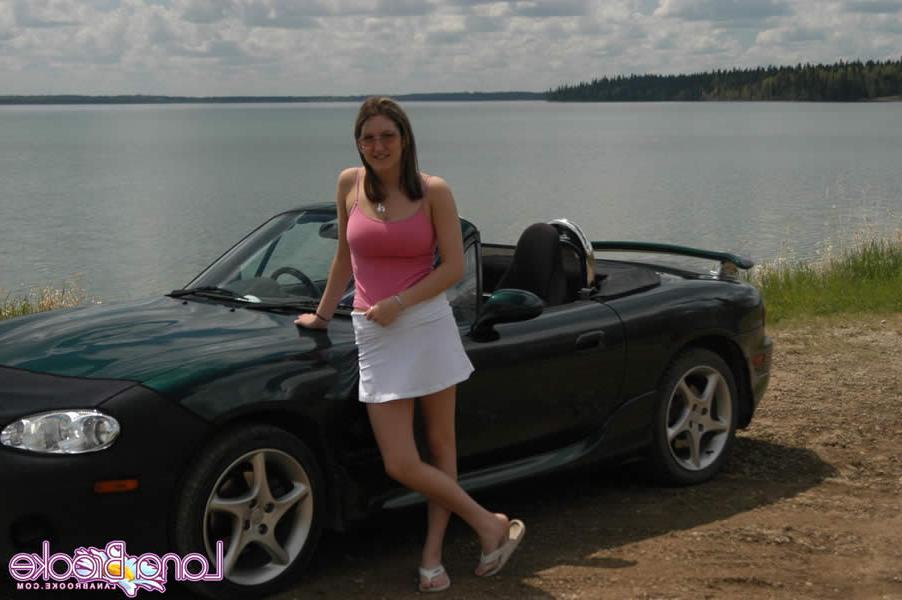 15P Brunette teen with big tits poses by a car