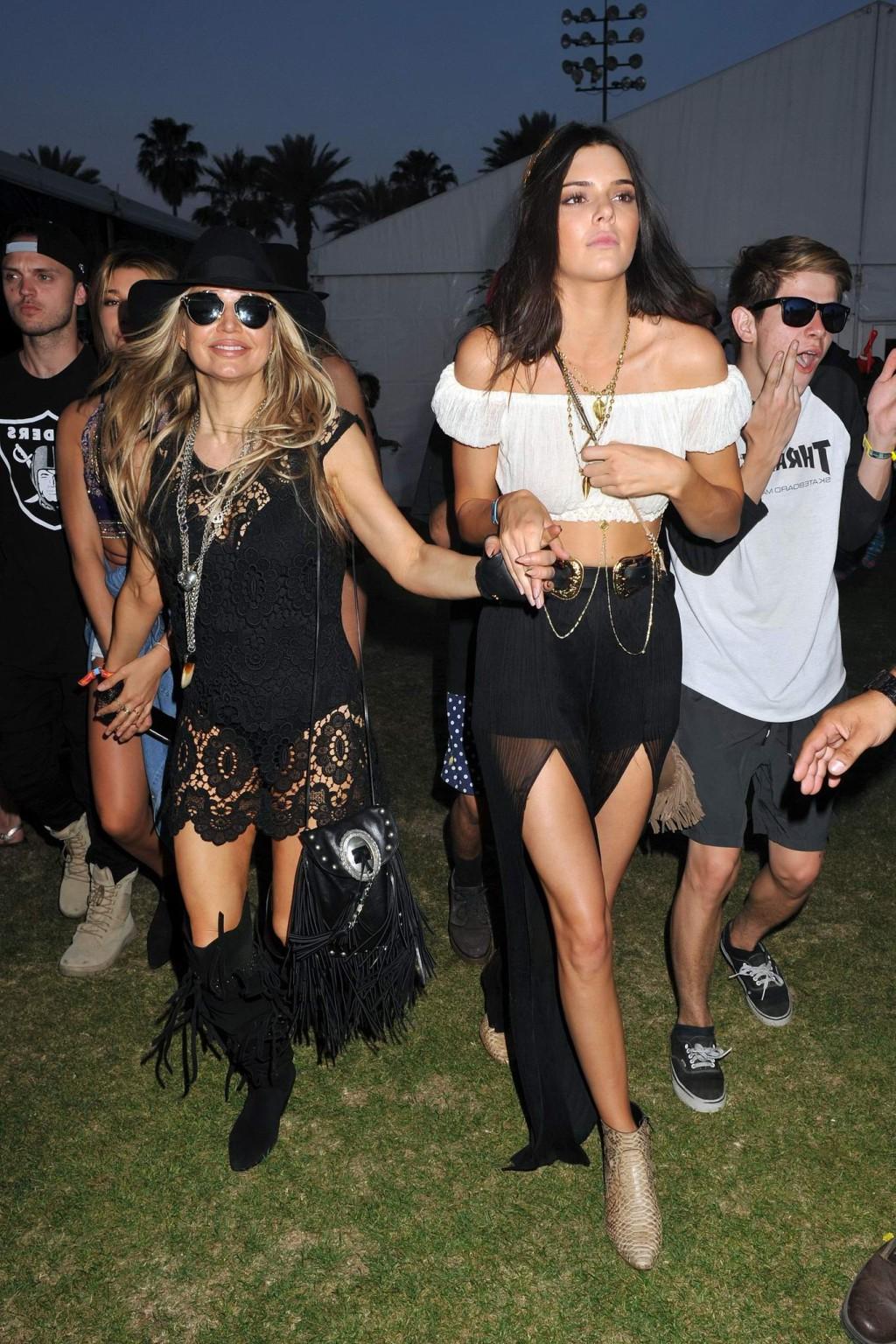 16P Kendall Jenner busty in a seethrough belly top and high slit skirt at Coachella 