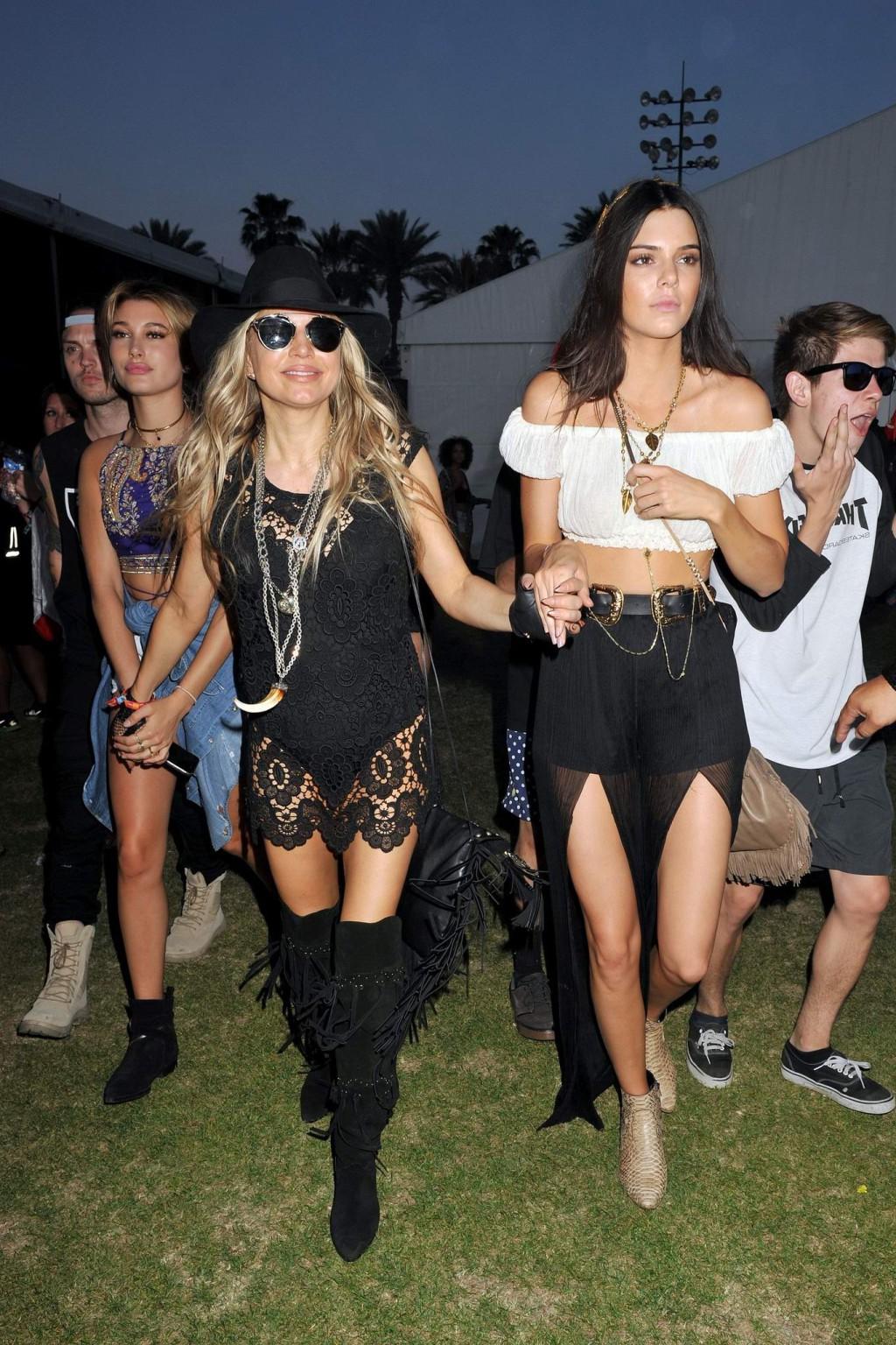 16P Kendall Jenner busty in a seethrough belly top and high slit skirt at Coachella 