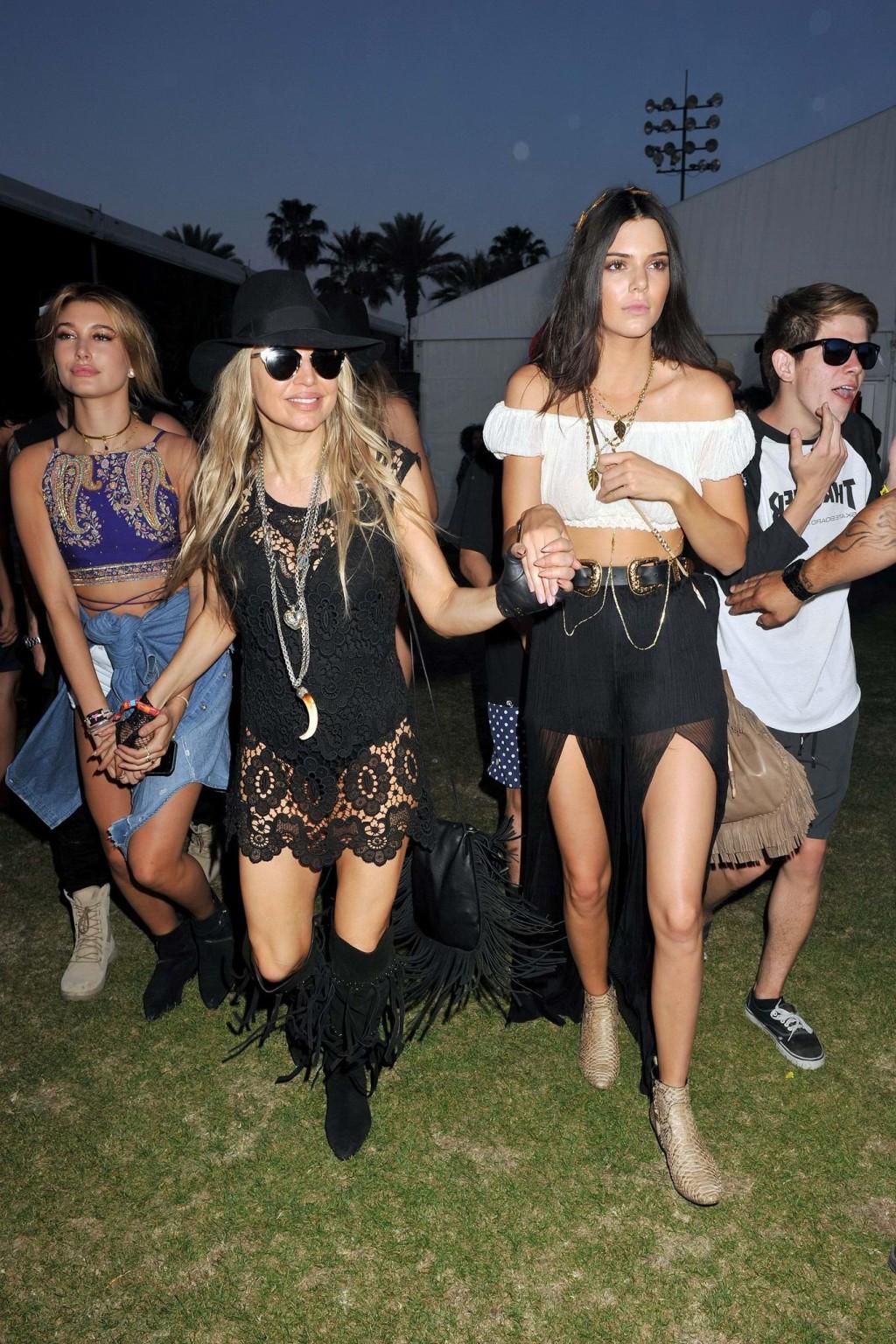16P Kendall Jenner busty in a seethrough belly top and high slit skirt at Coachella 