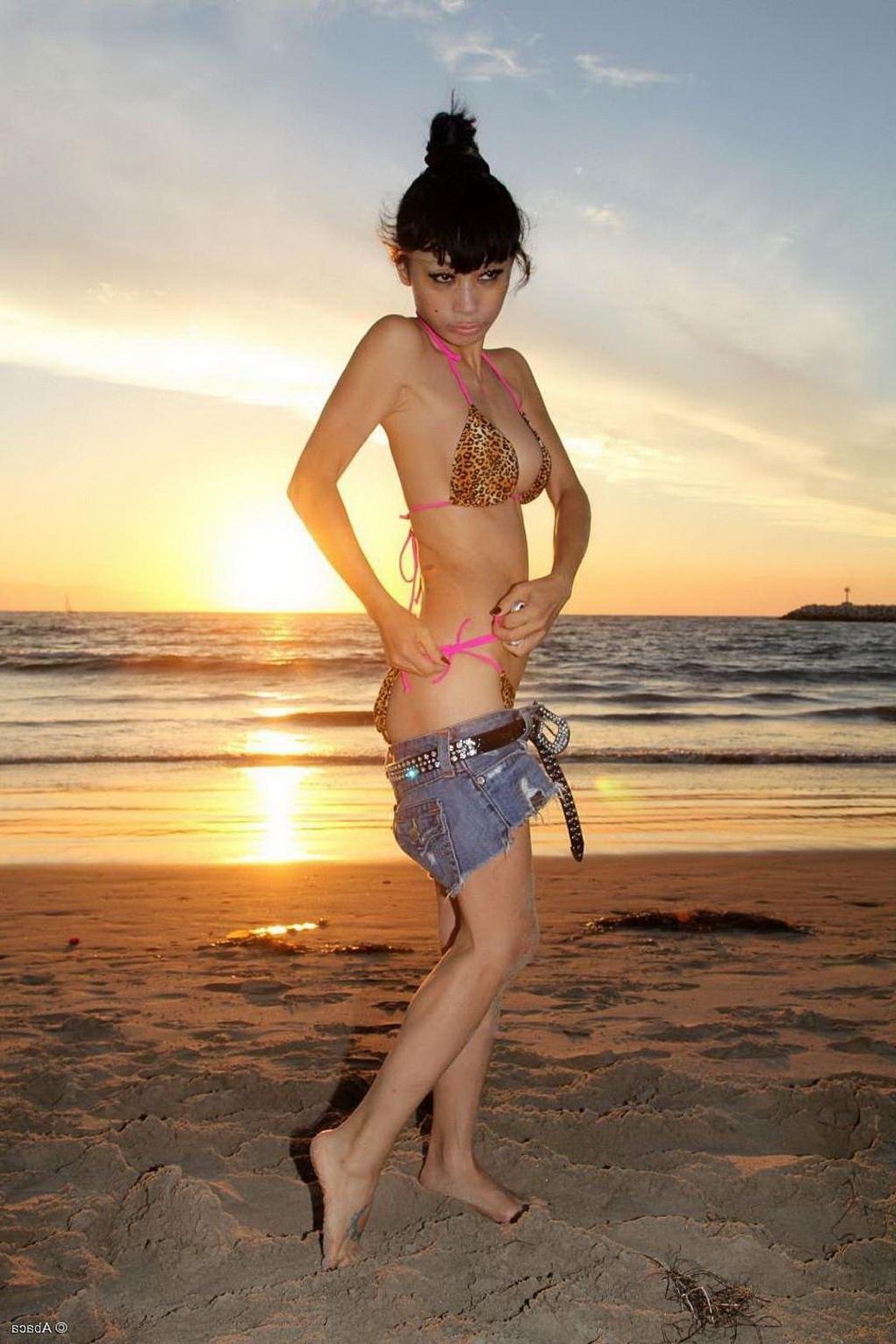 10P Bai Ling showing boobs in a seethru belly top and tiny leopard print bikini duri