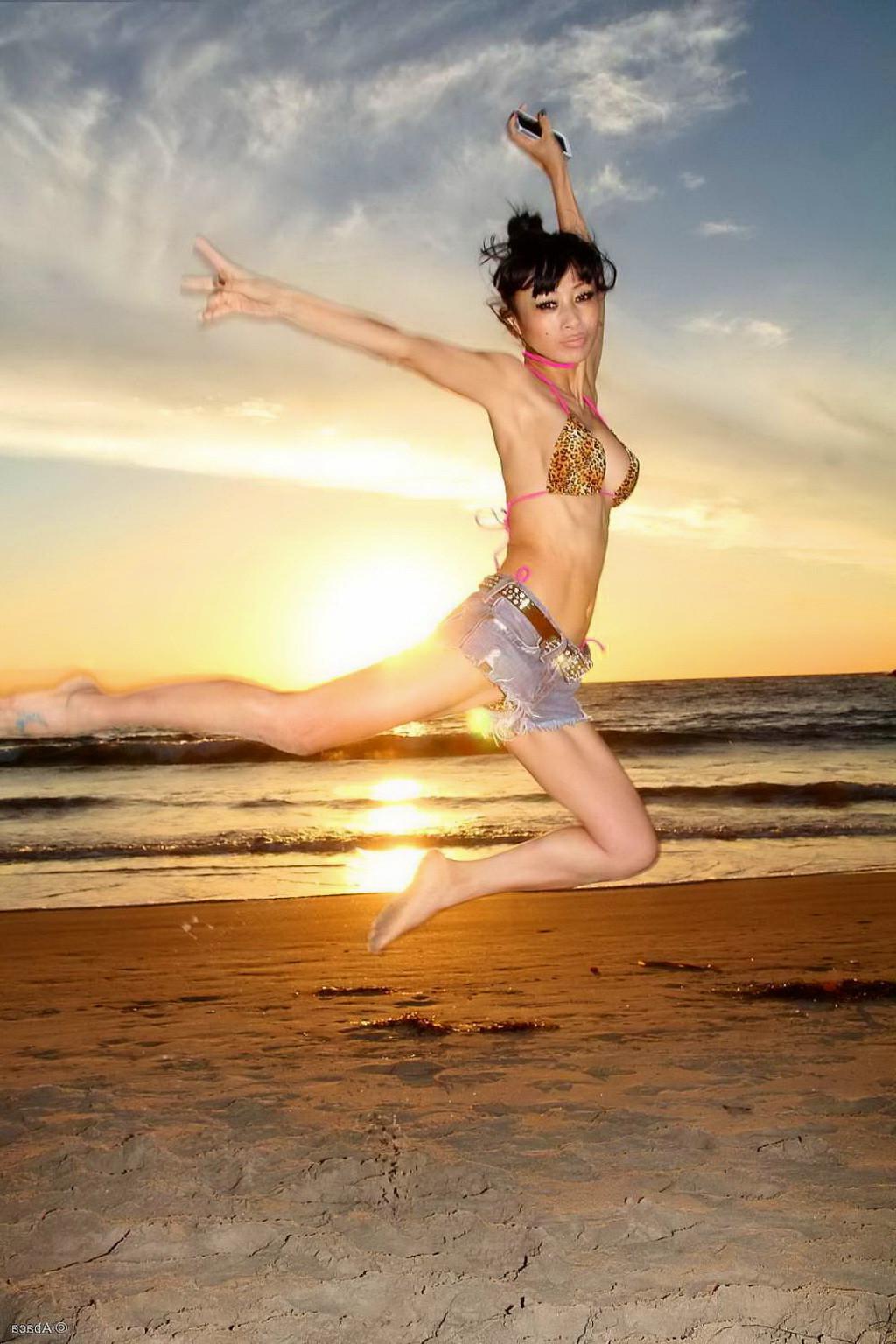 10P Bai Ling showing boobs in a seethru belly top and tiny leopard print bikini duri