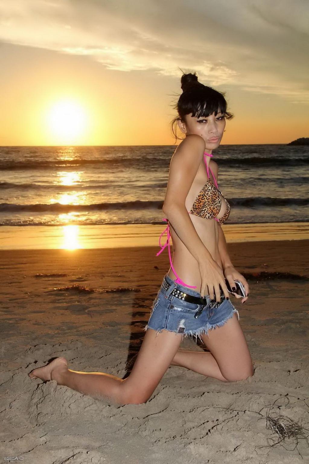 10P Bai Ling showing boobs in a seethru belly top and tiny leopard print bikini duri