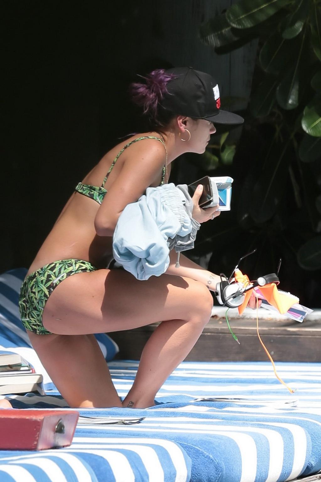 16P Lily Allen showing off her round butt in a leaf print bikini at the hotel pool i