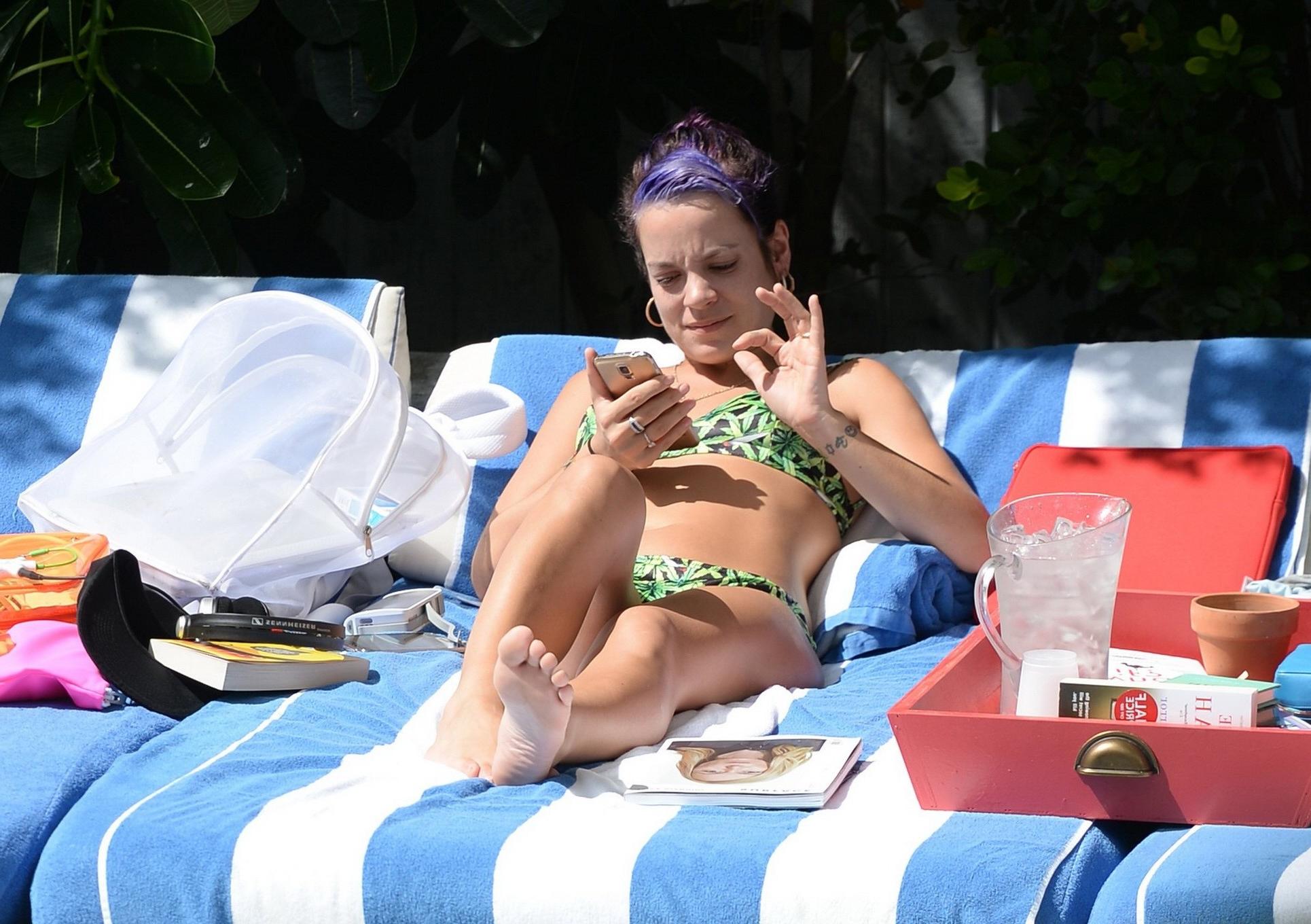 16P Lily Allen showing off her round butt in a leaf print bikini at the hotel pool i