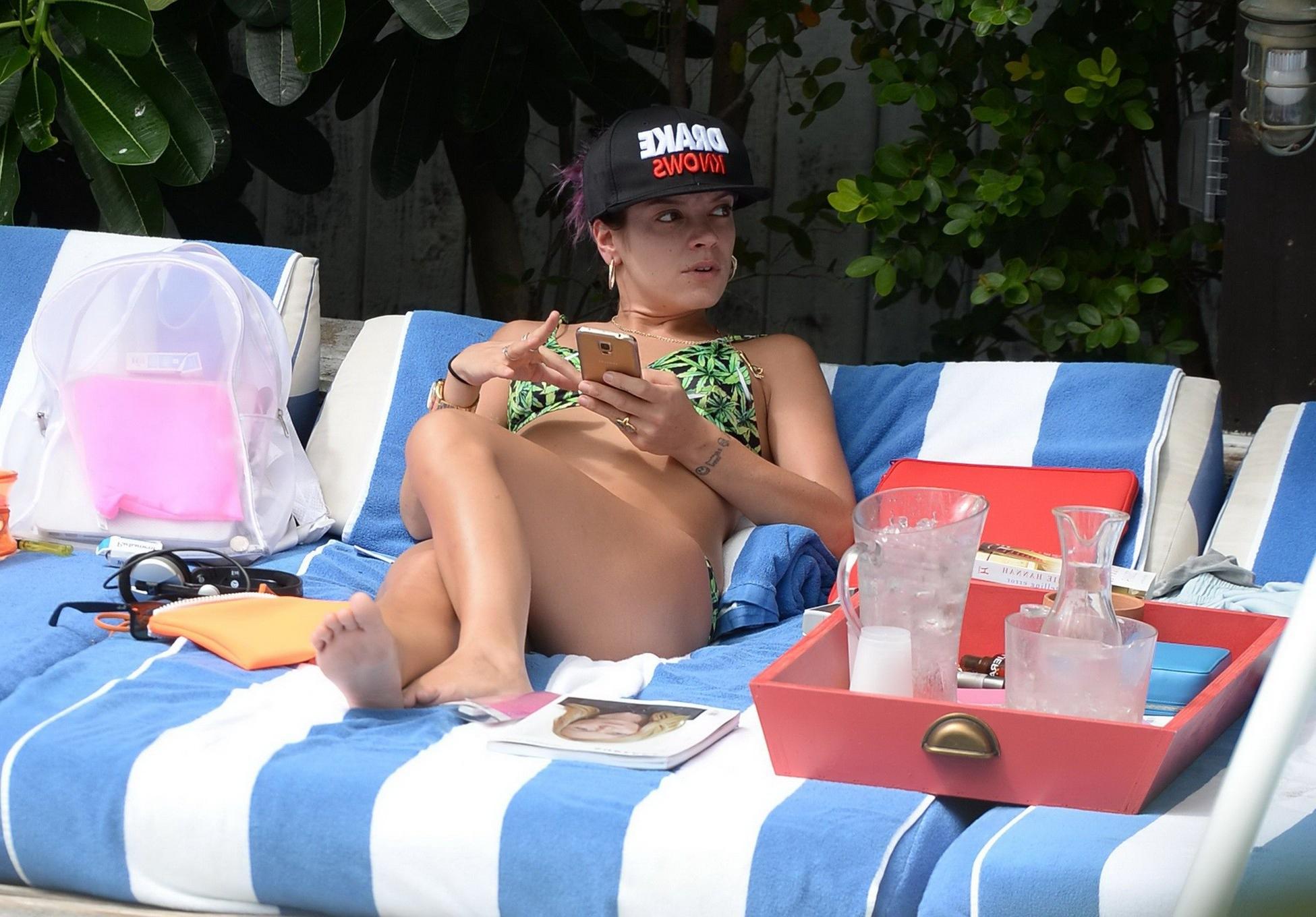 16P Lily Allen showing off her round butt in a leaf print bikini at the hotel pool i