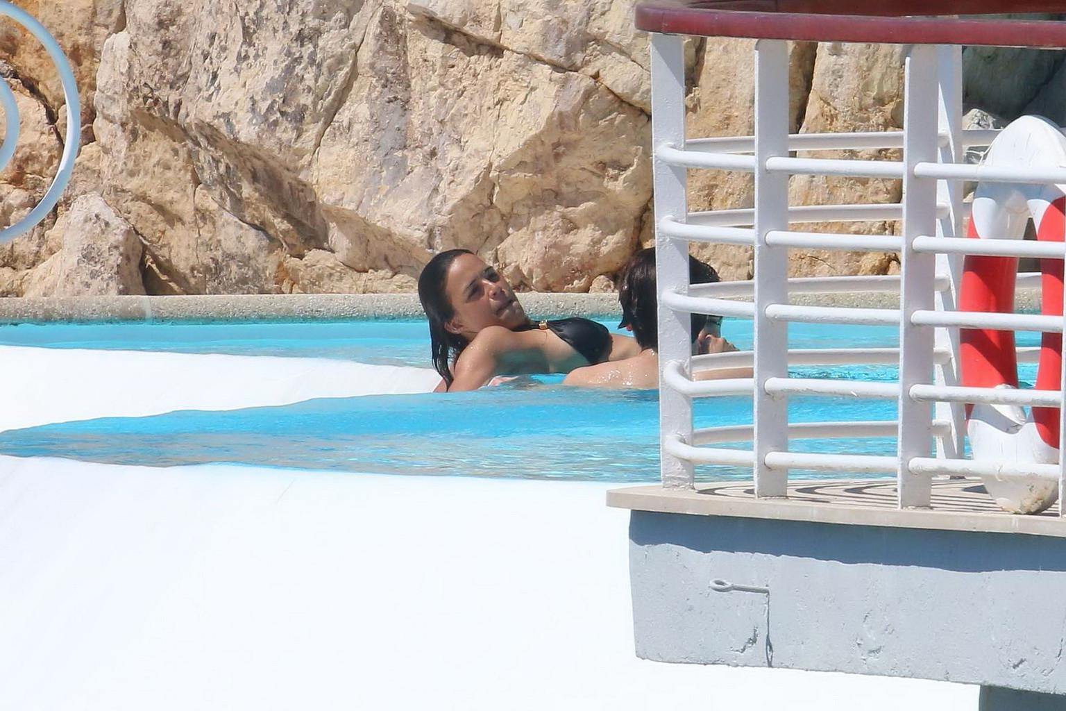 16P Michelle Rodriguez wearing skimpy black bikini poolside at Cap Eden Roc Hotel in