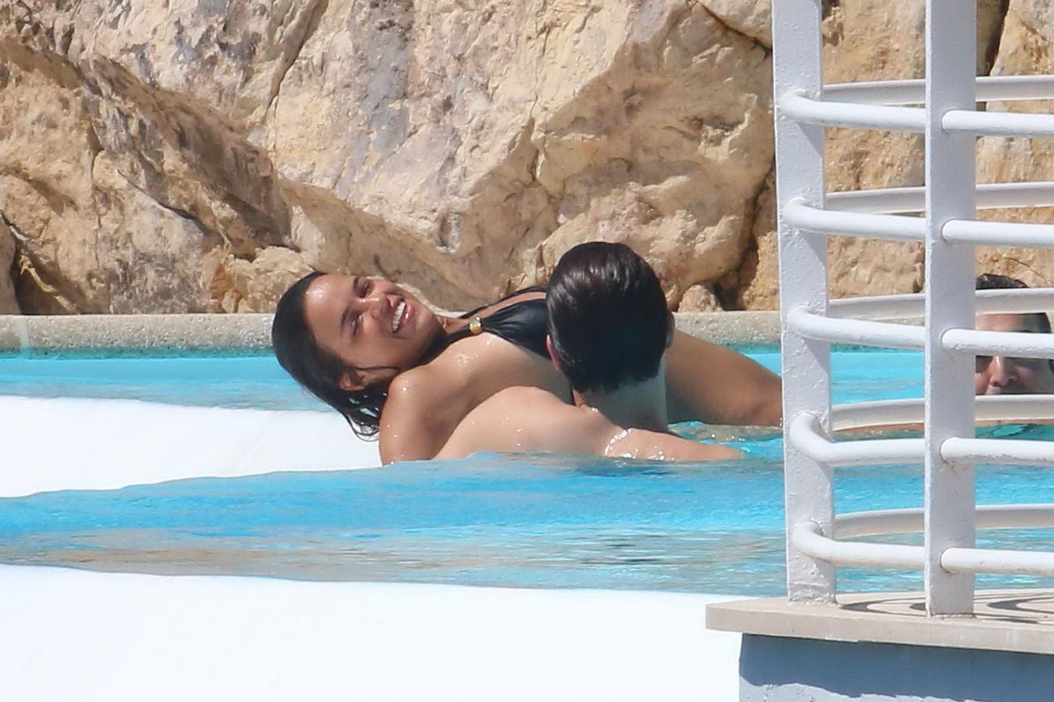 16P Michelle Rodriguez wearing skimpy black bikini poolside at Cap Eden Roc Hotel in