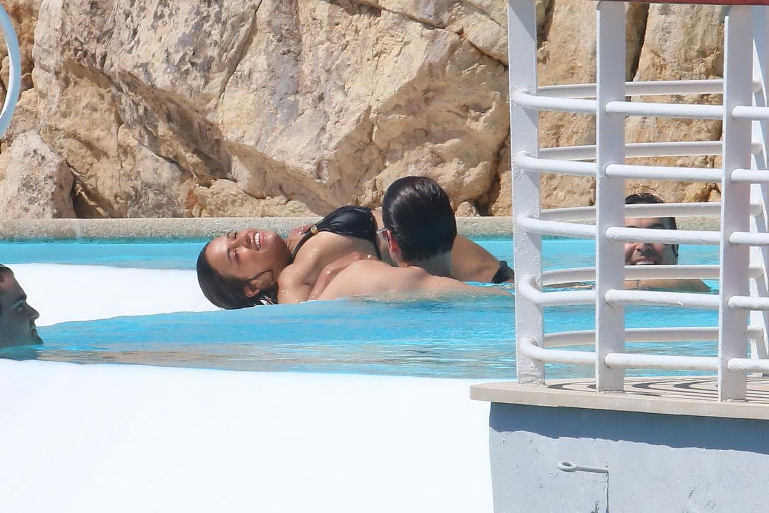 16P Michelle Rodriguez wearing skimpy black bikini poolside at Cap Eden Roc Hotel in