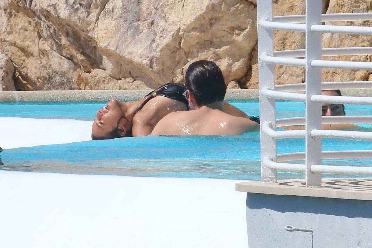 16P Michelle Rodriguez wearing skimpy black bikini poolside at Cap Eden Roc Hotel in