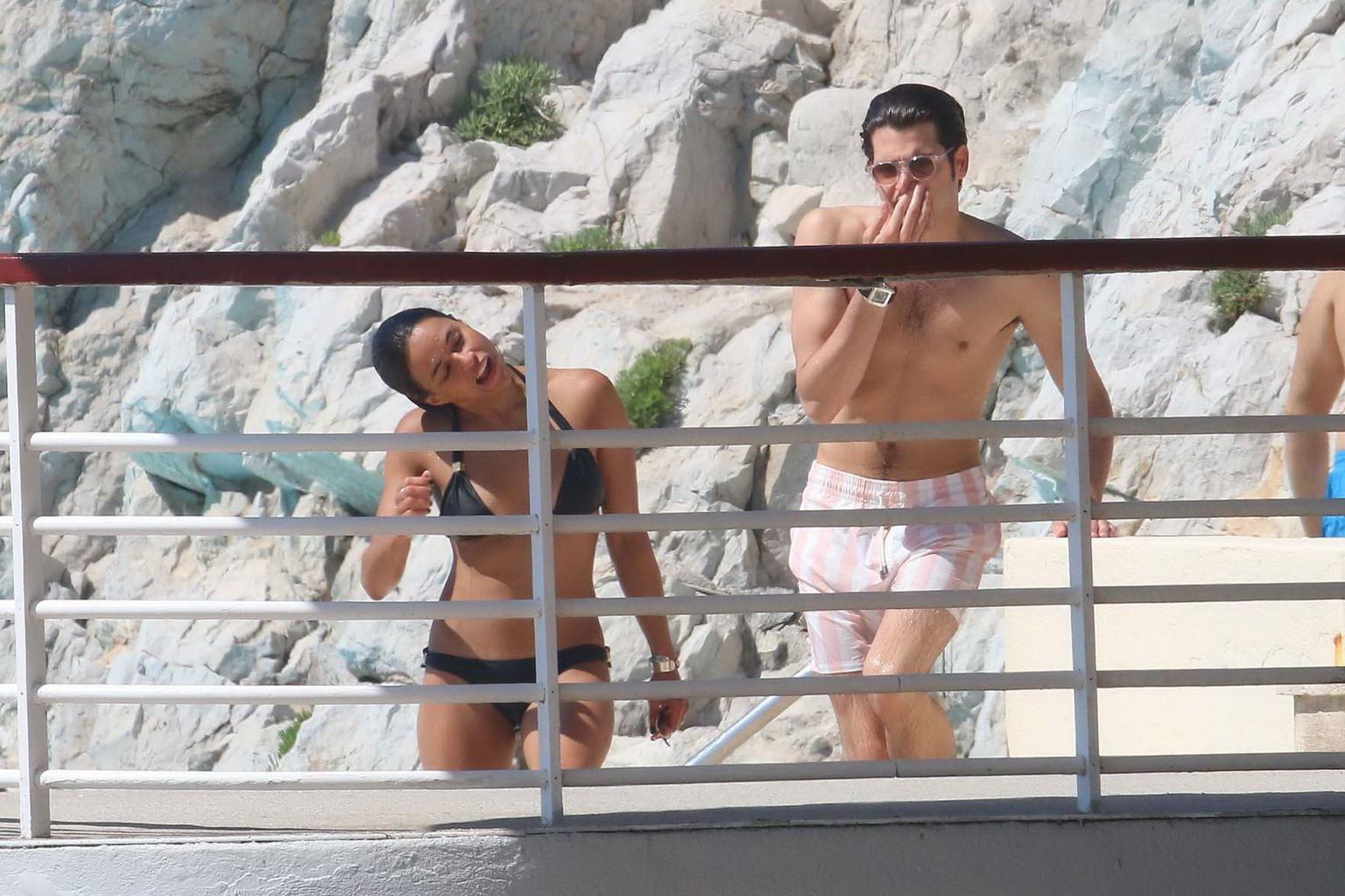 16P Michelle Rodriguez wearing skimpy black bikini poolside at Cap Eden Roc Hotel in