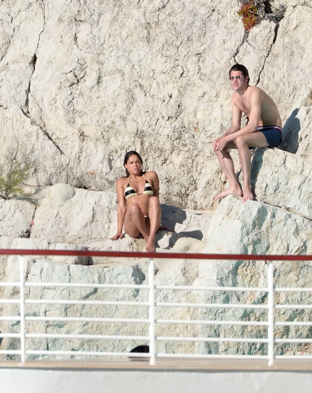 16P Michelle Rodriguez busty in a tiny striped bikini at the Hotel Du CapEdenRoc poo