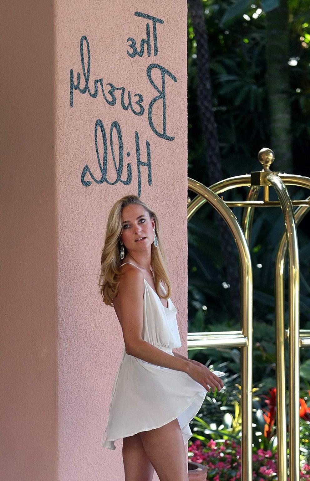 16P Kimberley Garner leggy wearing white mini dress outside the Beverly Hills Hotel