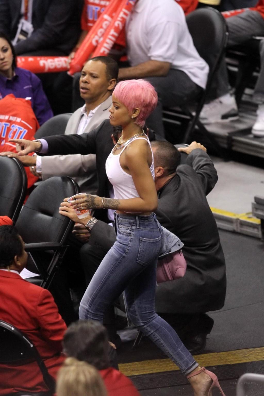 16P Rihanna braless wearing a white top at the Clippers game in LA