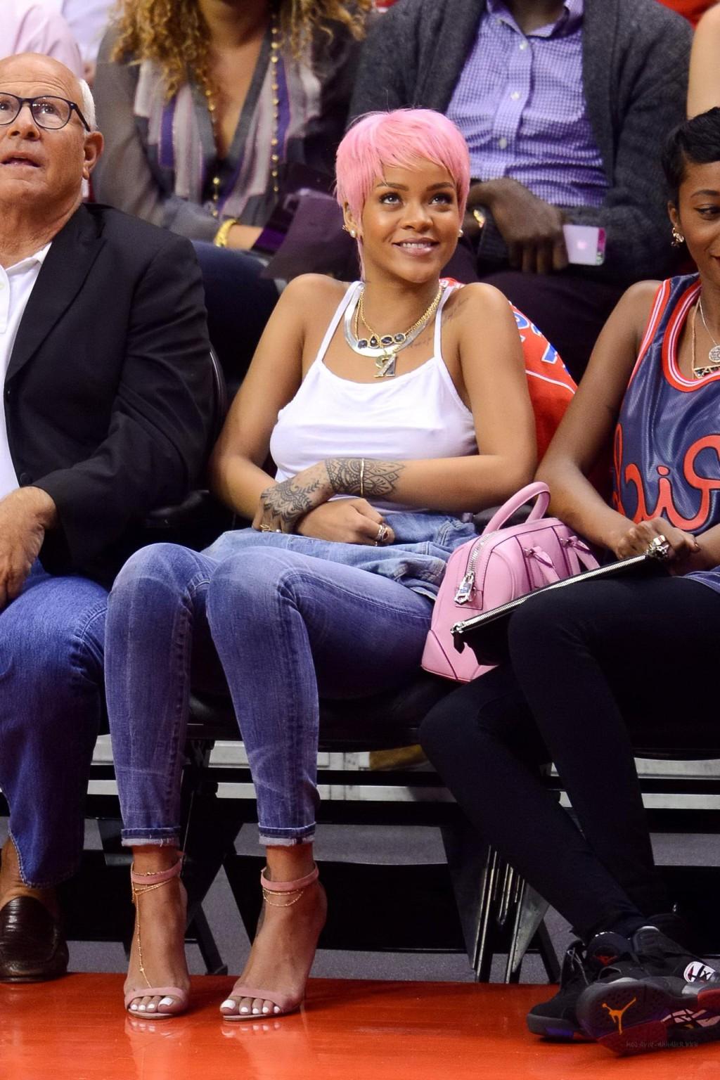 16P Rihanna braless wearing a white top at the Clippers game in LA