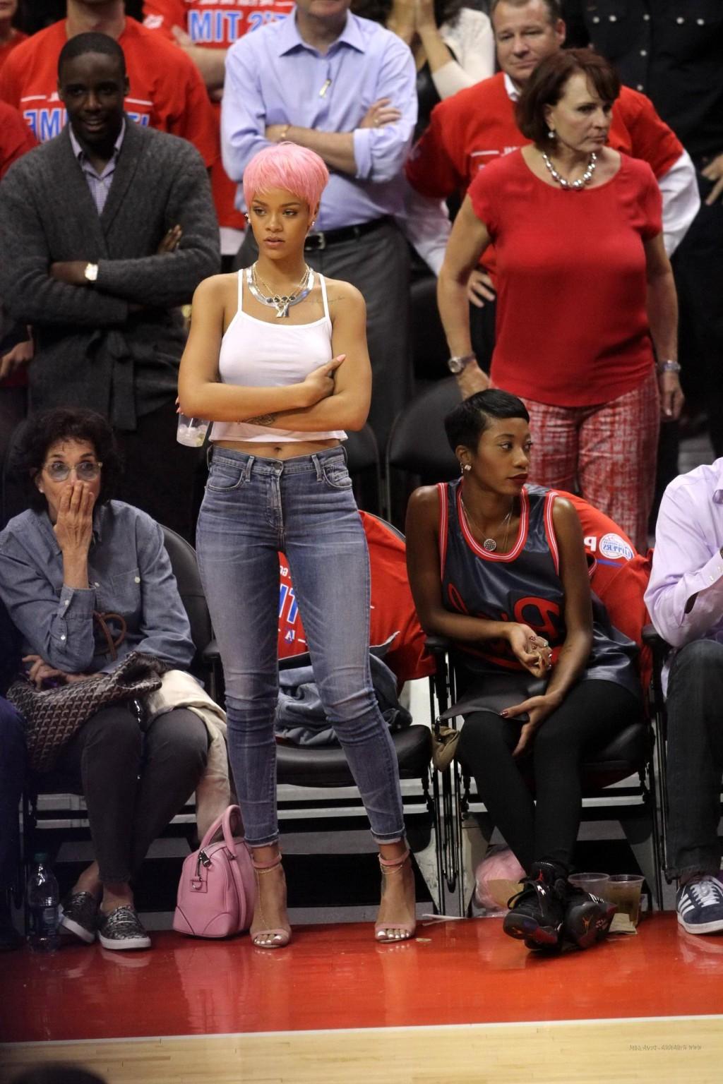 16P Rihanna braless wearing a white top at the Clippers game in LA